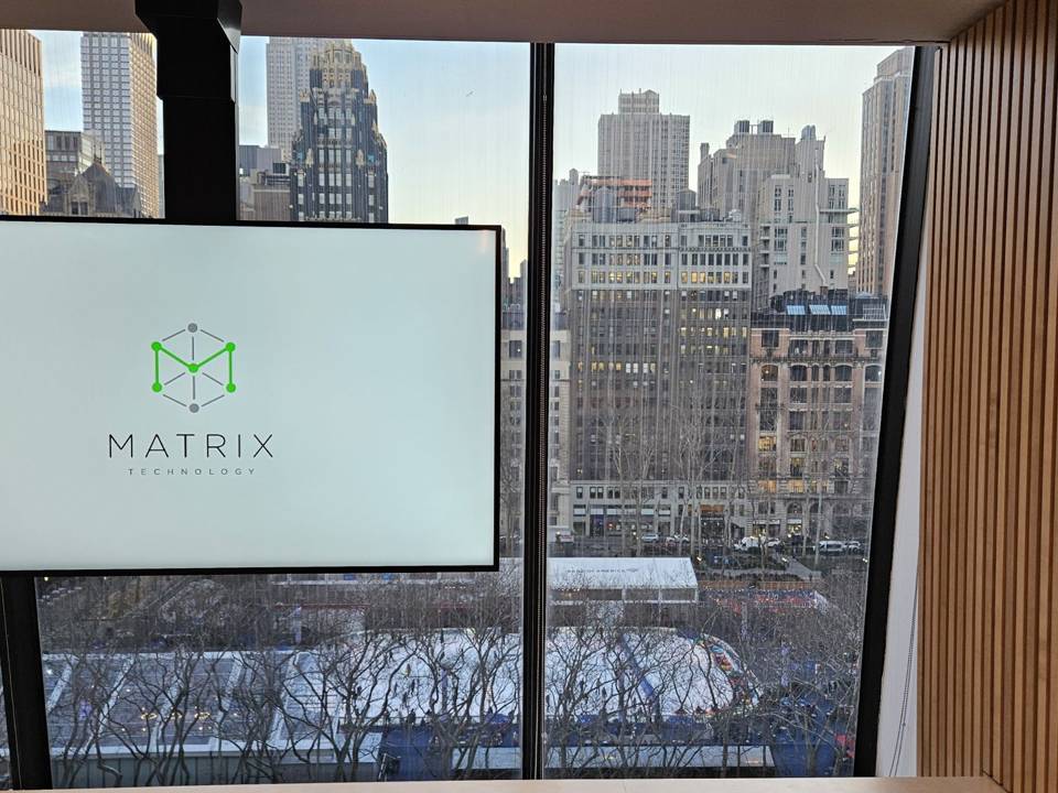 Corner meeting room with large display and city view