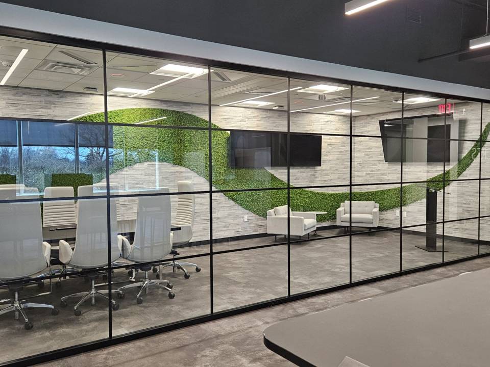 Glass-walled conference room with displays on two walls