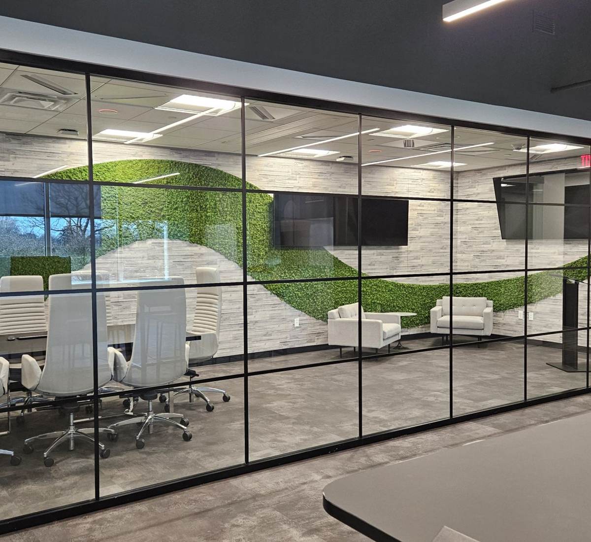 Glass-walled executive suite with displays and network connectivity in each room