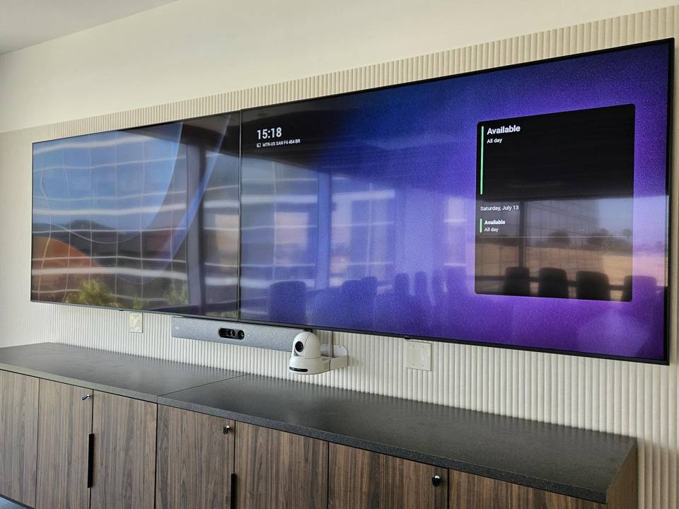 Dual-display video wall with PTZ camera and video bar above credenza
